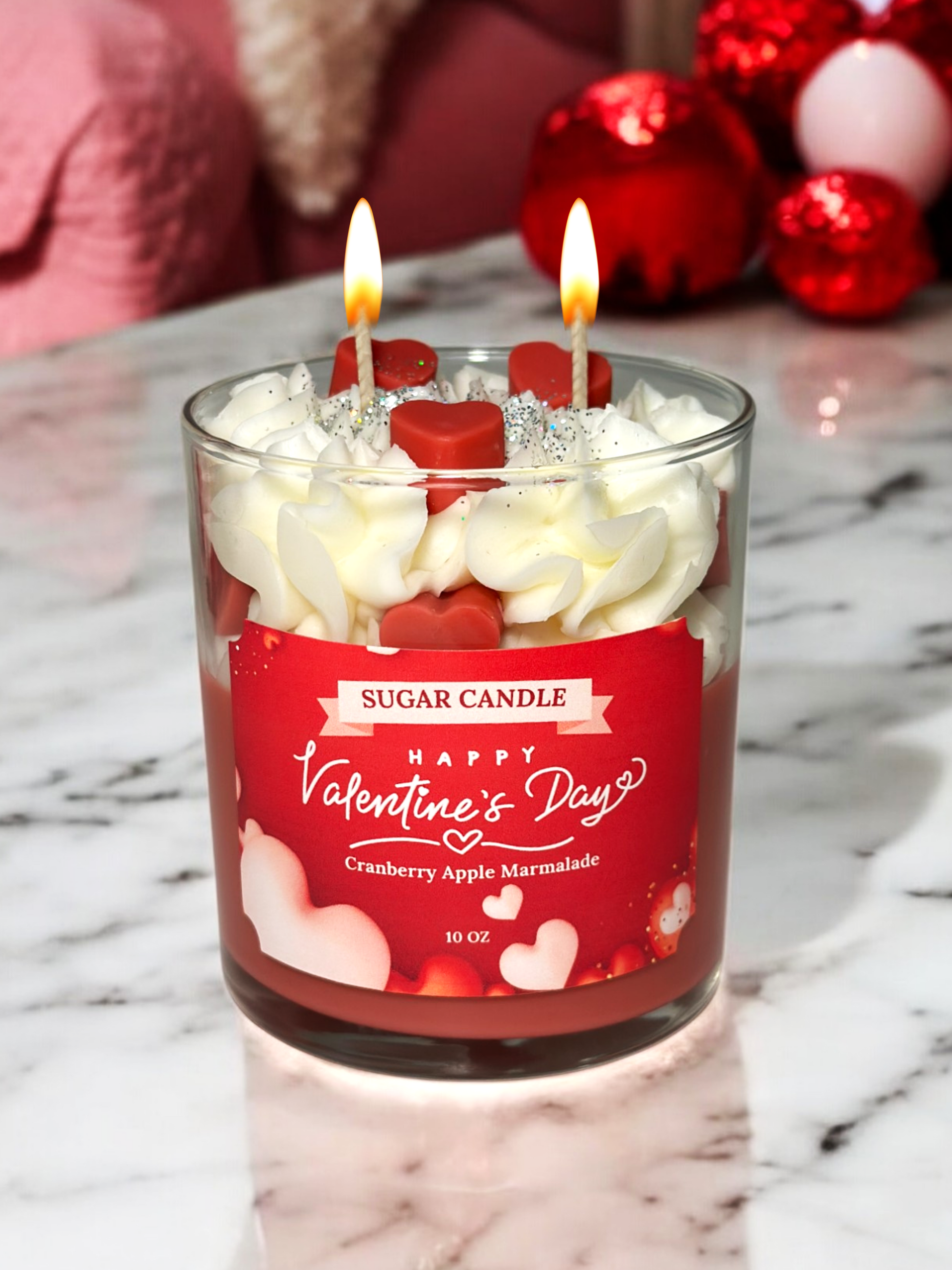 Valentine's Day-themed candle with a red label on a marble surface.