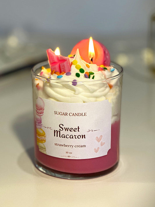 Candle labeled 'Sweet Macaron' with decorative elements on a neutral background