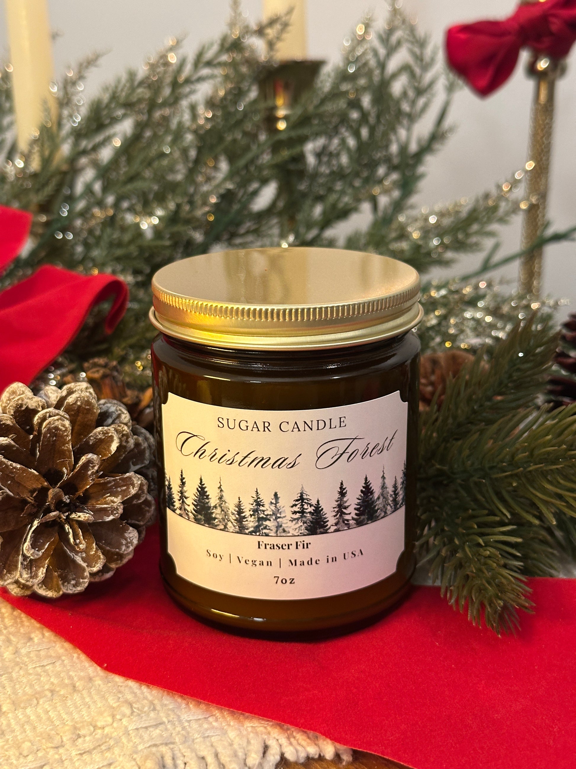 Jar of Christmas-themed candle with decorative elements on a red surface
