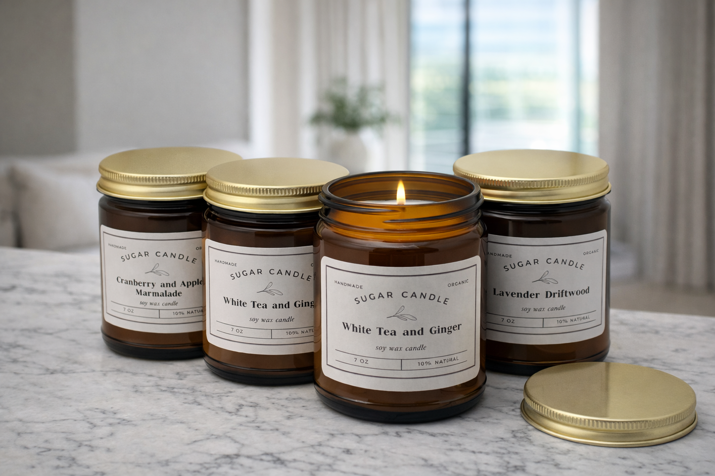 Four candles with labels on a marble surface, with a blurred indoor background.
