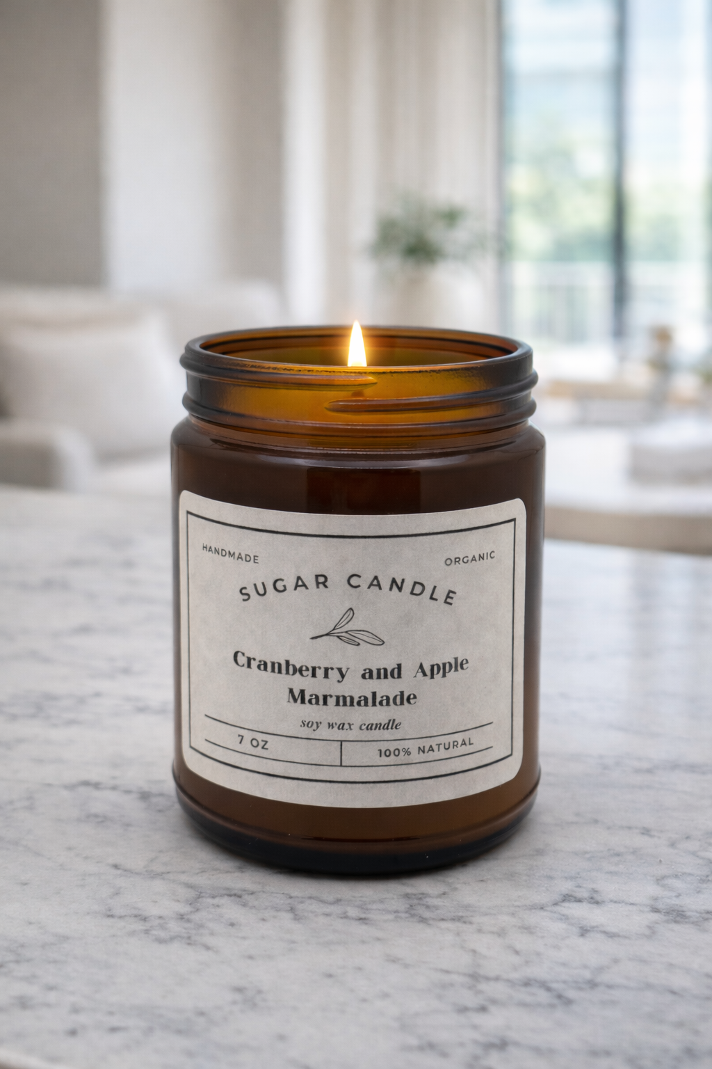 Scented candle in an amber jar with a label on a marble surface