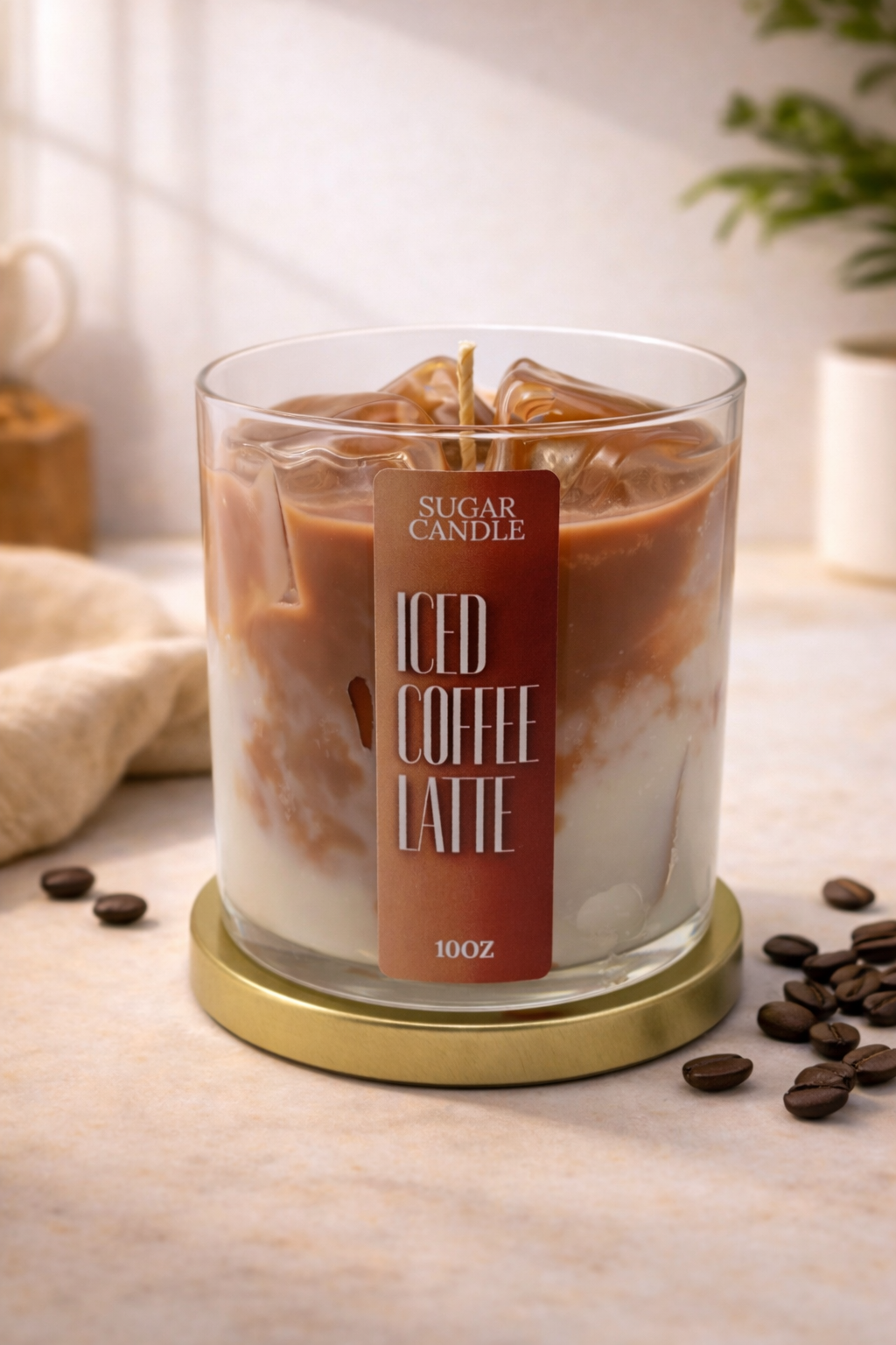 Candle labeled 'Iced Coffee Latte' with coffee beans on a light surface