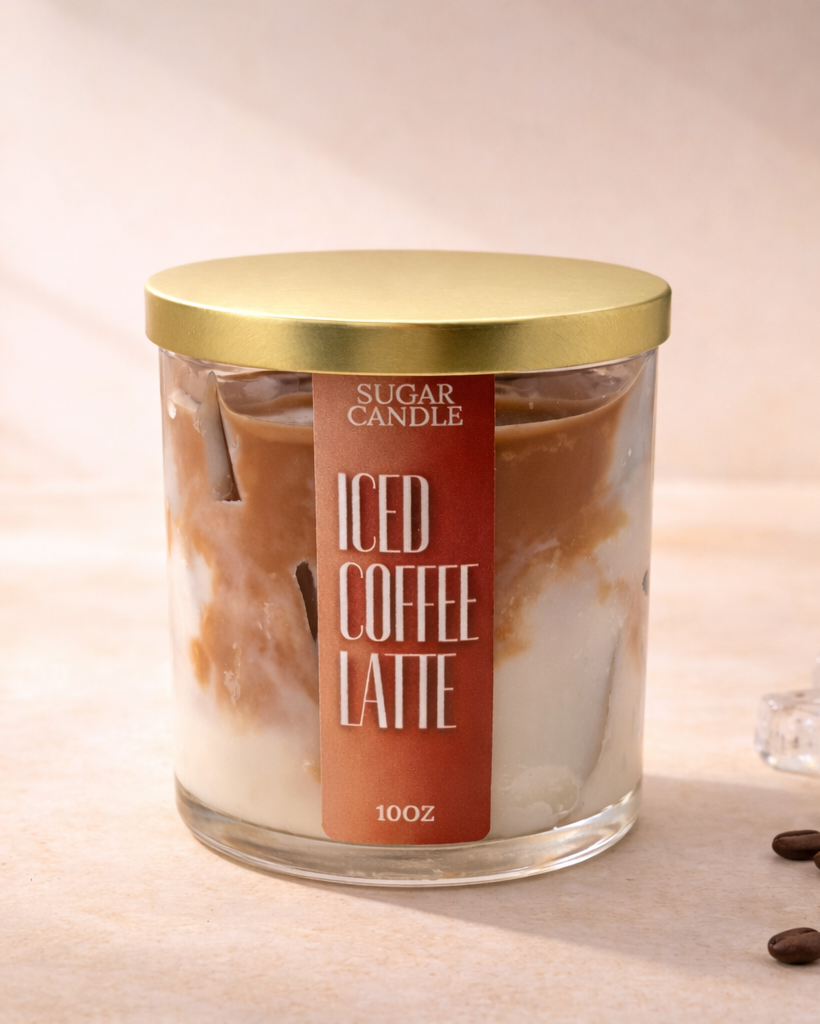 Candle labeled 'Iced Coffee Latte' with coffee beans and ice cubes on a surface.
