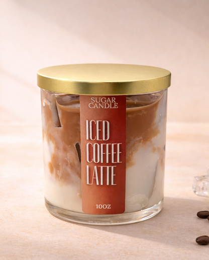 Candle labeled 'Iced Coffee Latte' with coffee beans and ice cubes on a surface.