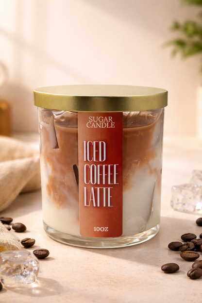 Glass candle labeled 'Iced Coffee Latte' with coffee beans and ice cubes on a soft background