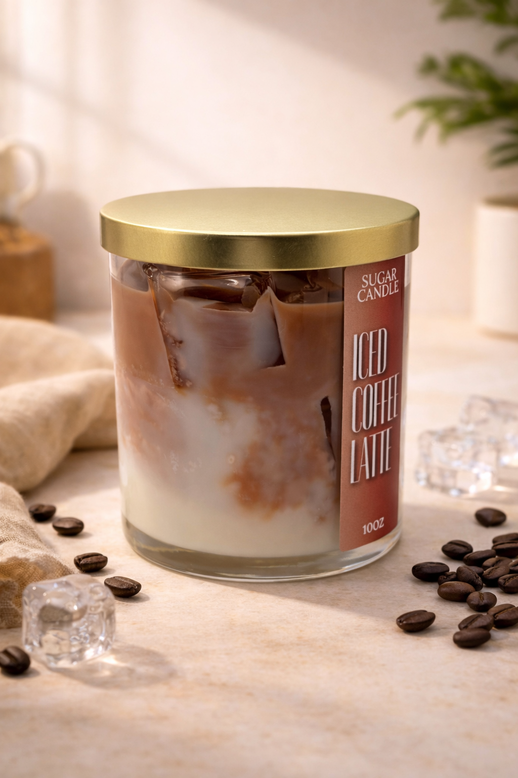 Candle labeled 'Iced Coffee Latte' with coffee beans and ice cubes on a surface