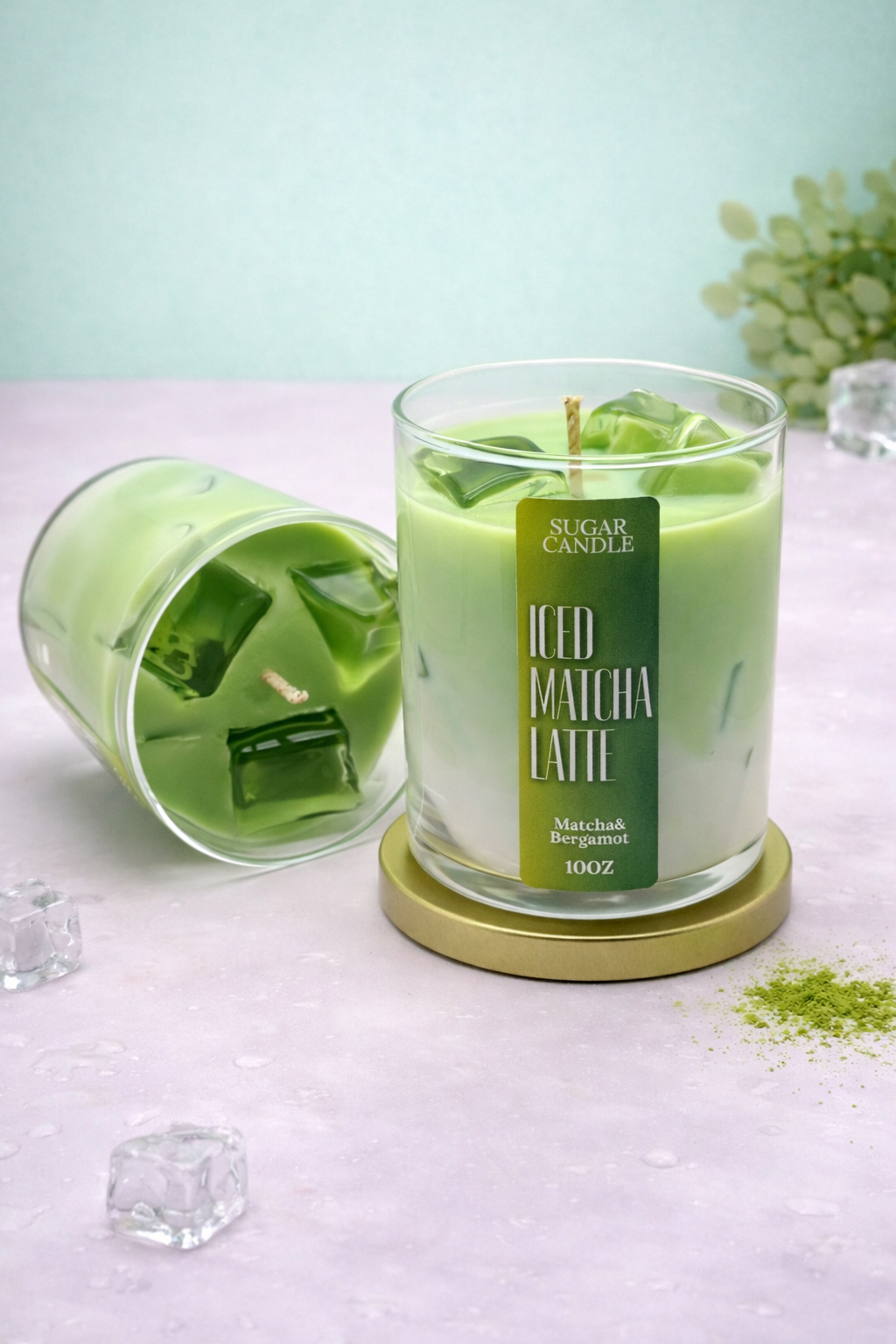 Green candle labeled 'Matcha Latte' on a light surface with a blurred background