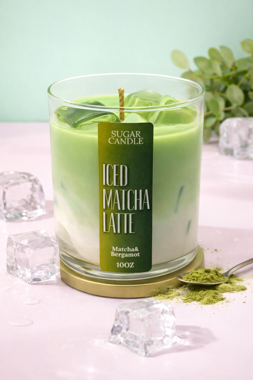 Green candle labeled 'ICED MATCHA LATTE' with matcha powder and ice cubes on a light background