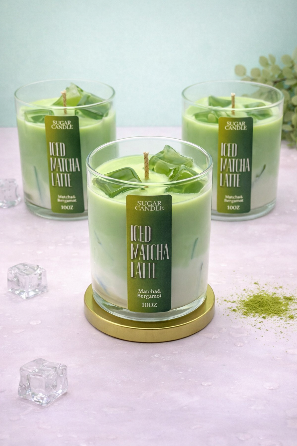 Three green iced matcha latte candles with 'Sugar Candle' labels on a light surface.